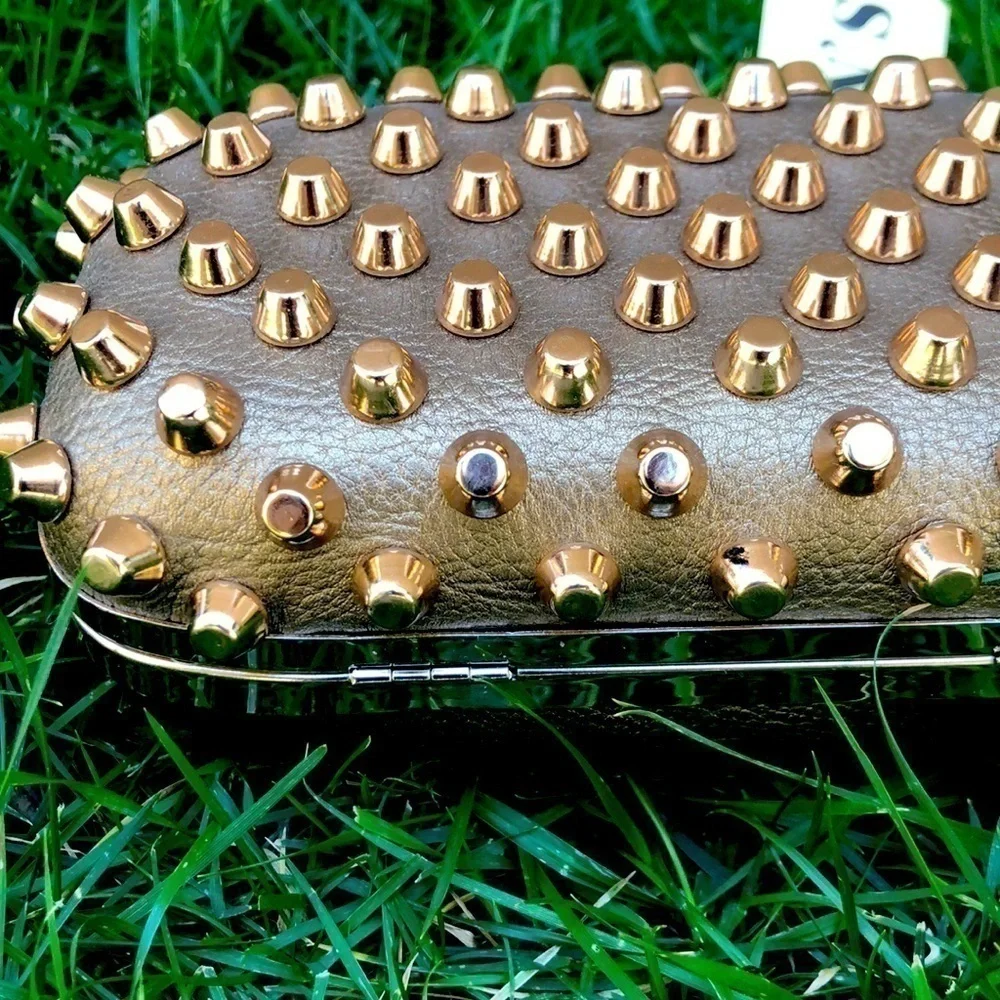 Skulls knuckles ring handles, rhinestone spikes studded clutch.